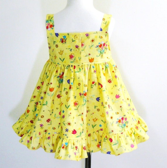 Yellow sundress/pinafore and panties adorned with whimsical