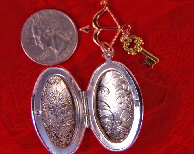 Elongated Floral Decorated Silver-tone Locket with Archery and Key Charms