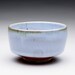 chawan tea bowl with soft light blue and orange shino glazes