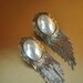 Vintage 80s flapper style,large clip on earring accented with white faux pearl and silvertone metal tassel.