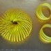 Vintage 60s yellow slinky bracelet with matching hoop clip on earrings.One size fits all.