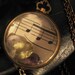 vintage watch case filled with genuine treasures amethyst topaz and feathers
