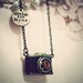Traveler. Nostalgic honey crystal filled camera pendant with a hand stamped antiqued brass tag necklace