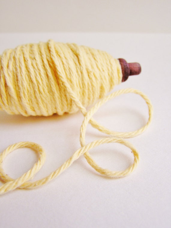 Buttercream thick cotton twine on a chocolate spindle