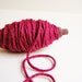 Burgundy thick cotton twine on a chocolate spindle
