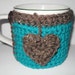 crocheted coffee mug cozy or tea cup cozy in beautiful peacock blue trimmed in barley brown with heart tea bag