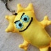Soft keychain, whimsical creature with evil grin - makes great stocking stuffer, bright canary yellow