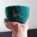 fuzzy felted teal blue green wool bowl with the word love embroidered in white
