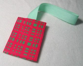 Neon pink and green luggage tag