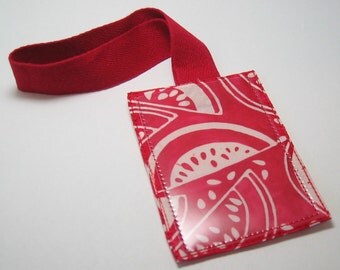 Red and white watermelon luggage tag with red webbed strap