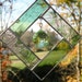 Stained Glass Sunchatcher with Peridot colored crystal hanging in the middle