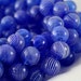 GLASS HOLLOW Roundelles....Blue with white swirl... 10 beads 12mm in diameter (HG-08)