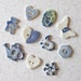 Handmade Porcelain Button Medley. Ten Assorted Blues. Watering Can, Teddy Bear, Butterfly, Snowflake, Bunny, Hearts, Oval & Hexagon