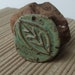 Carved Sage Leaf ceramic pendant with rustic edging. Handmade with stoneware clay
