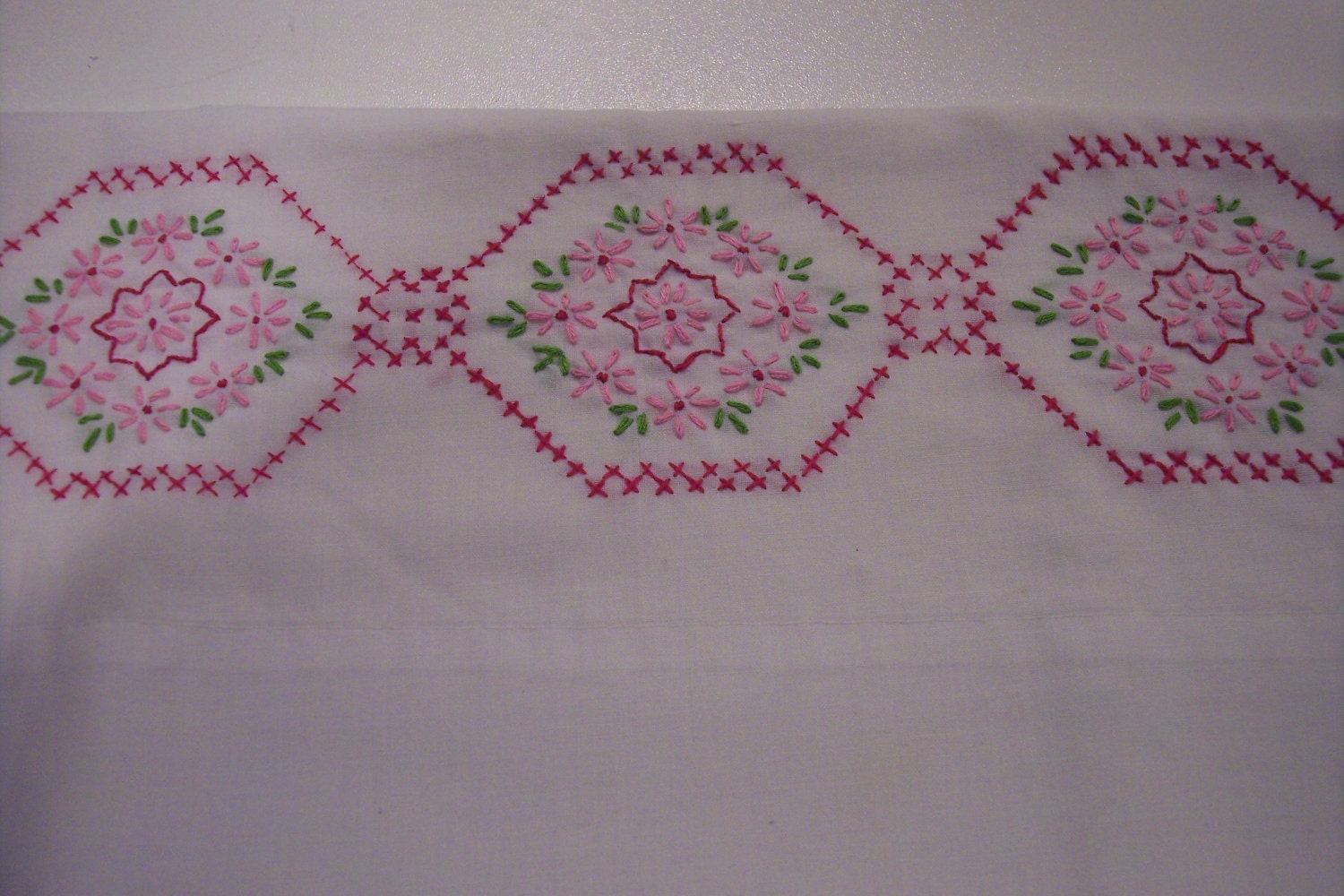 Hand embroidery on vintage pillowcase Pink flower pattern