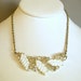 Vintage Bogoff silver tone collar necklace with white plastic leaves