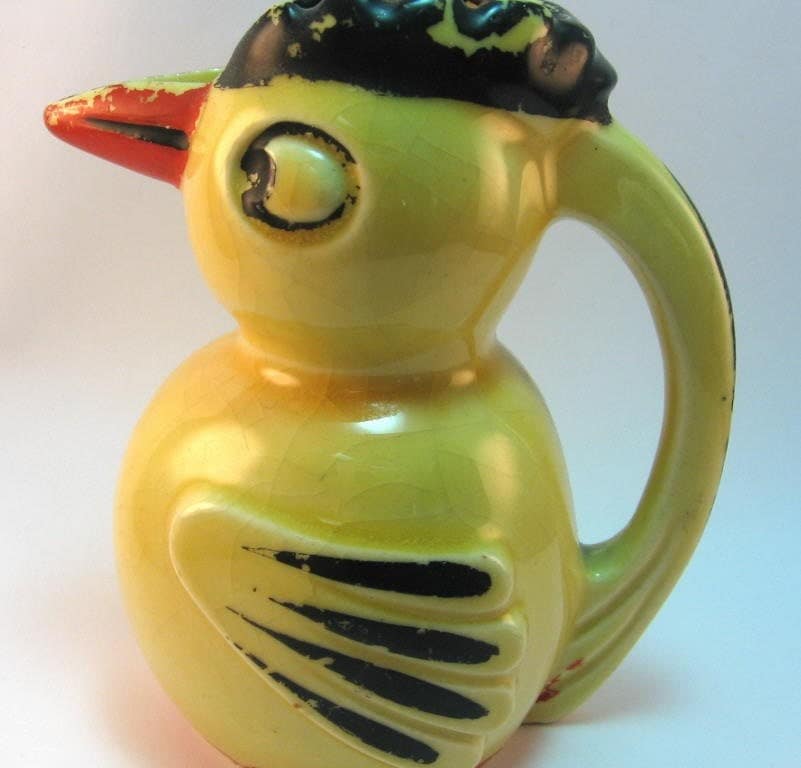 yellow ceramic bird figurine