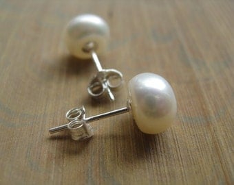 white pearl earrings in sterling silver. pearl stud earrings. silver earrings.