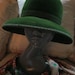 Striking plush deep moss green structured hat with unique ribbon