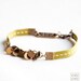 Bracelet Antique gold-plated brass charms and green ribbon