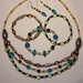 No desription would do jewelry set, necklace, three bracelets, dangle earrings, teals, brwons, greens, golden, tans, ivory, black