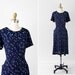 vintage 1940s 40s dress // Navy Blue Floral Dress with Pockets, Velvet Bows, and a Front Toggle Zipper