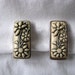 Rectangle ivory color flowery carved earrings with silver edging