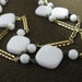 Long gold tone vintage chain necklace with square & round white beads