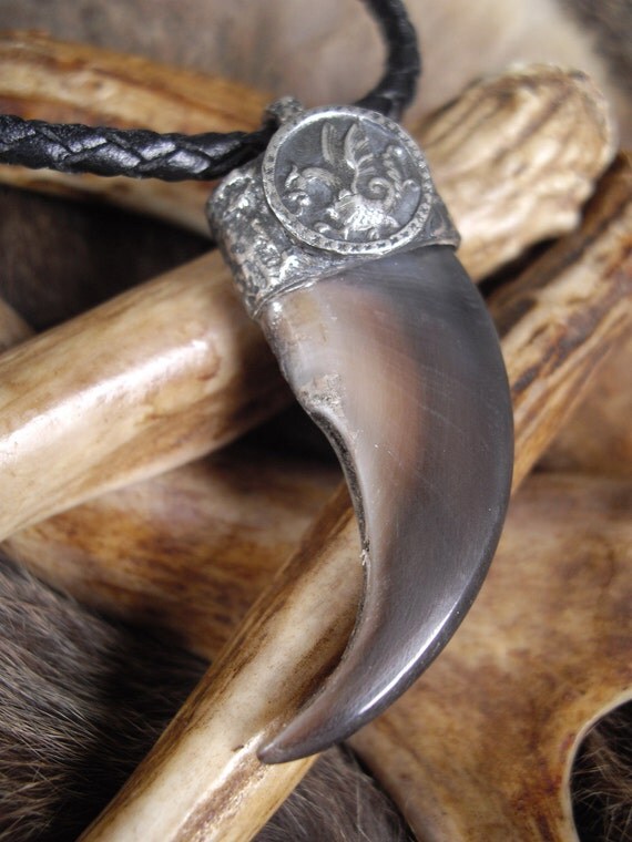real bear claw set in a pure silver cap with a dragon