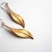 Gold feather earrings. Gorgeous vintage brass leaf or feather pendants on new 14K gold fill ear wires.