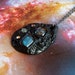 Black polymer clay pendant with labradorite and dichroic glass cabochons