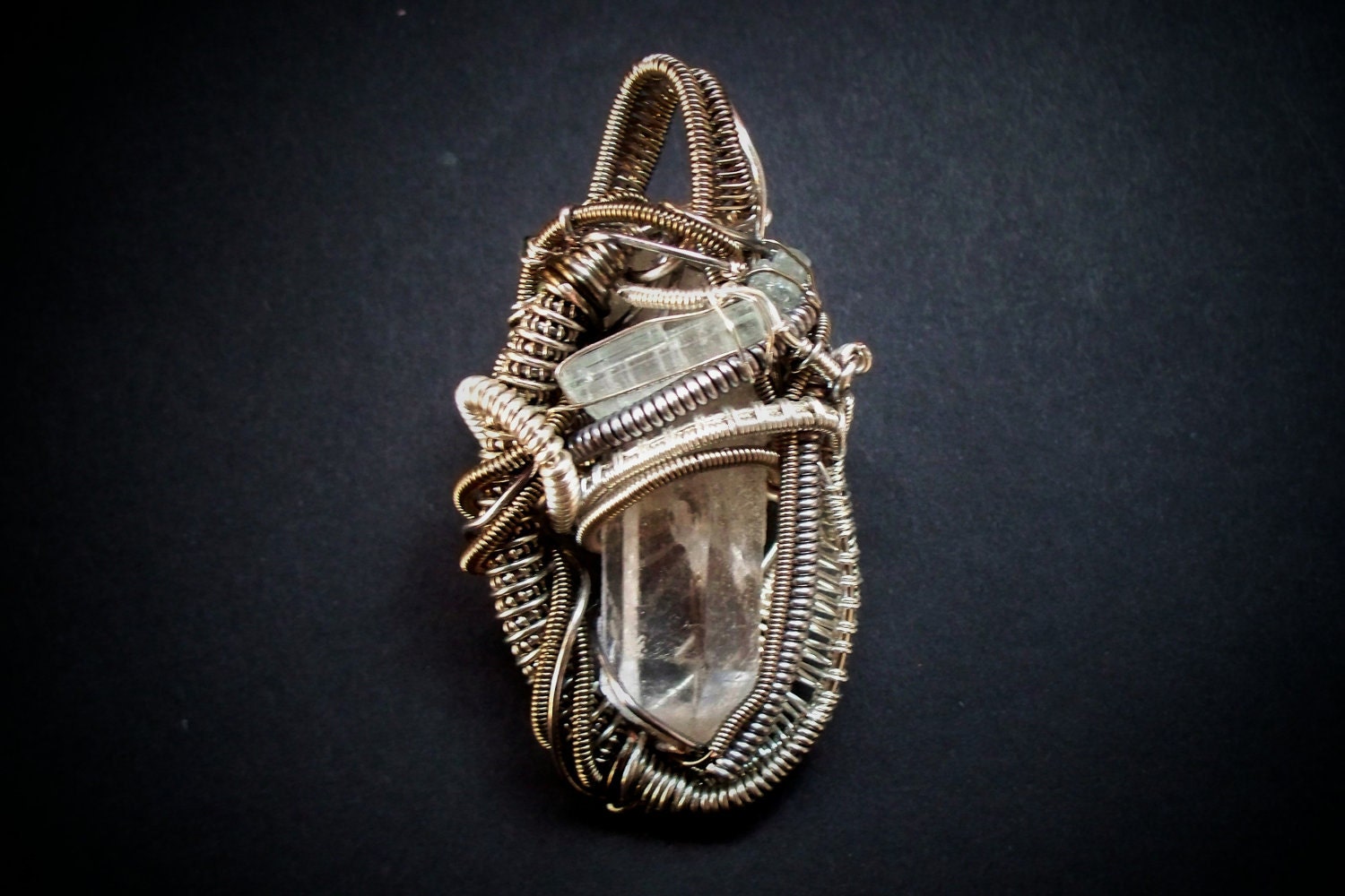 Intricate wire wrapped quartz crystal and tourmaline pendant