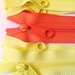 Seven yellow and orange 9 inch YKK Hand bag zippers with extra long pull