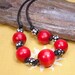 Red wood bead necklace, black red and white spotted beads on cord.