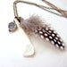 Talisman necklace w feather tooth and paw print