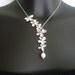 Asymmetrical flowers cascade necklace in white gold (N129)
