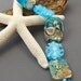 Shoreline Seagull, folk art style seagull and ocean crunch glass beads, set of 9 beads.