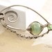 Handmade silver shawl pin in sage green with a hint of blue swirly ornate shape with Unicorne lampwork and Czech glass beads