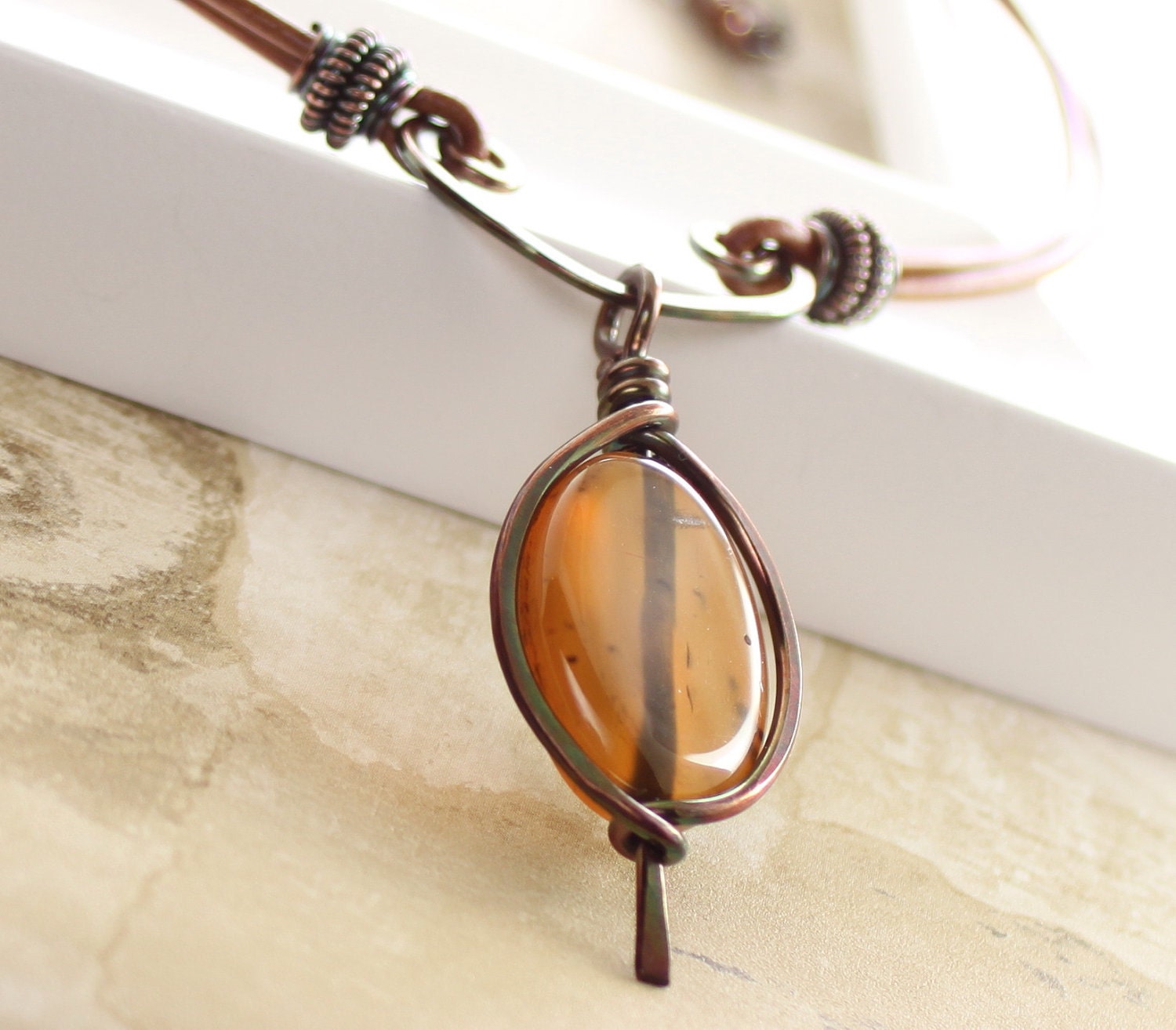 Framed honey brown agate copper necklace on arch with brown