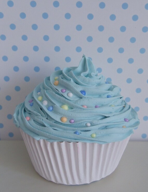 Sweet Cupcake with light  blue frosting  with colorful candy for
