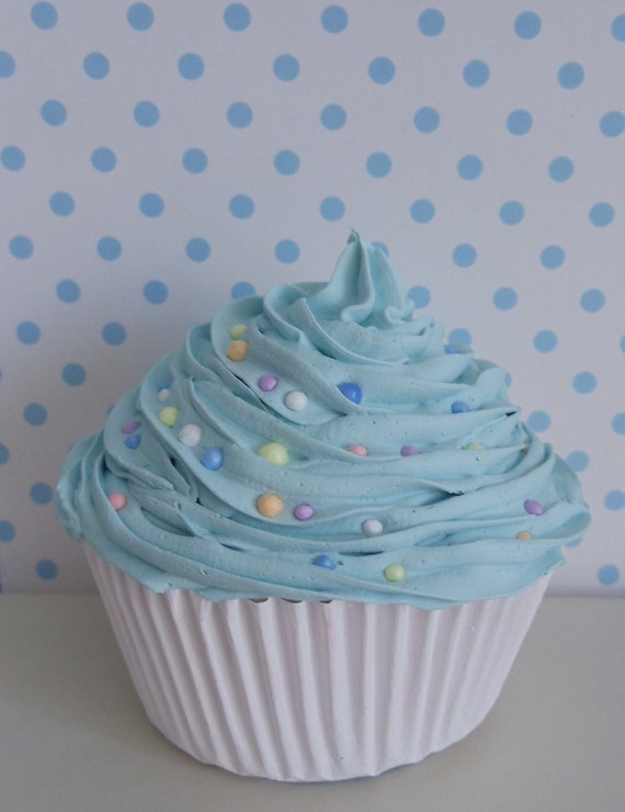 Sweet Cupcake with light  blue frosting  with colorful candy for