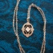 Vintage Necklace - Carved flower on enamel background, detailed silver tone pendant