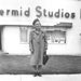 Vintage 1950s Photograph Woman Standing in Front of Photo Studio Smiling.