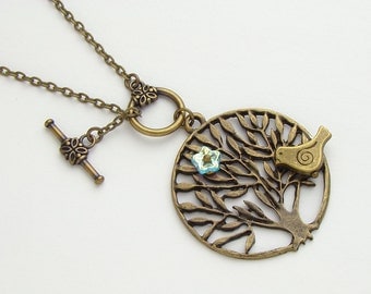Antiqued gold brass bird birdie on tree of life branch necklace blue glass flower pendant jewelry design by Steampunk Nation R1062
