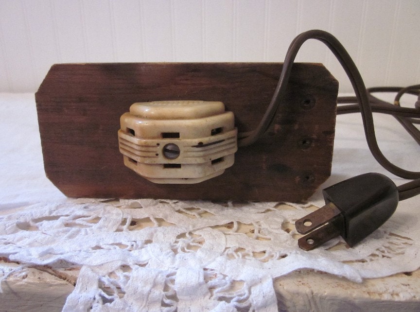 vintage extension cord mounted on wood rustic distressed