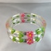 Vintage Reverse Carved Clear Lucite Bracelet. Pink and Yellow Flowers. Green Leaves.