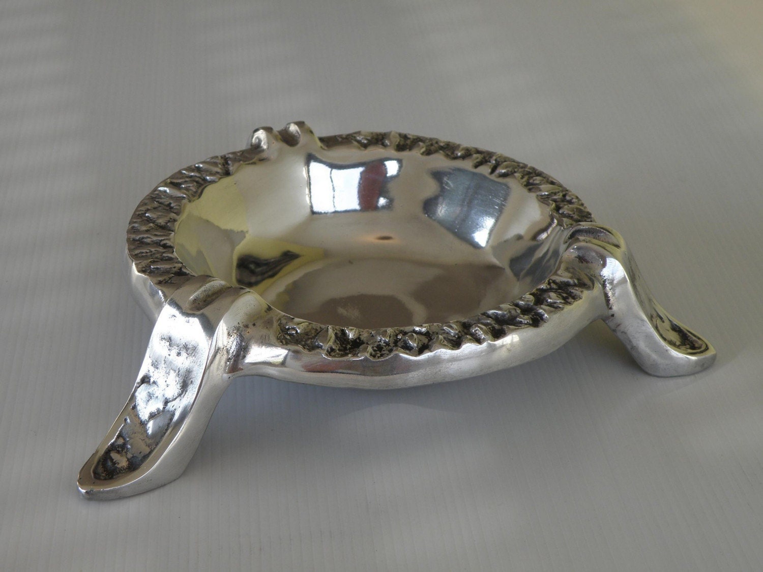 Cast and polished aluminum ashtray