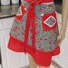 Sexy ,Bella Claire half apron in a black and white check print ,with ared cherry motif