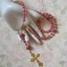Catholic rosary with dark pink glass pearls