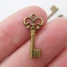 50 Key charms 21 x 9mm antique bronze tone
